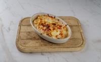 Gratinirani domači njoki z gobami, pršutom in svežim paradižnikom